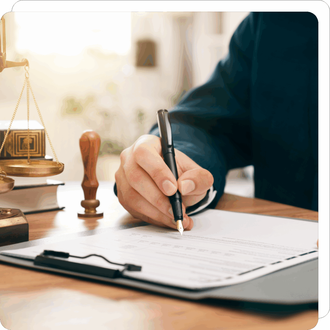 Signing document at a desk with pen.