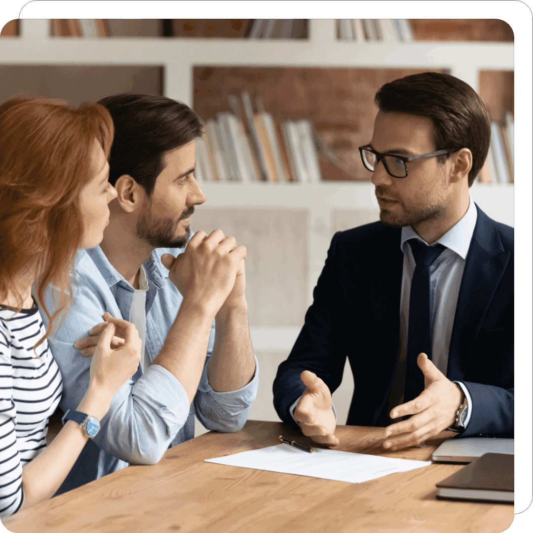 Three people discussing at a table.