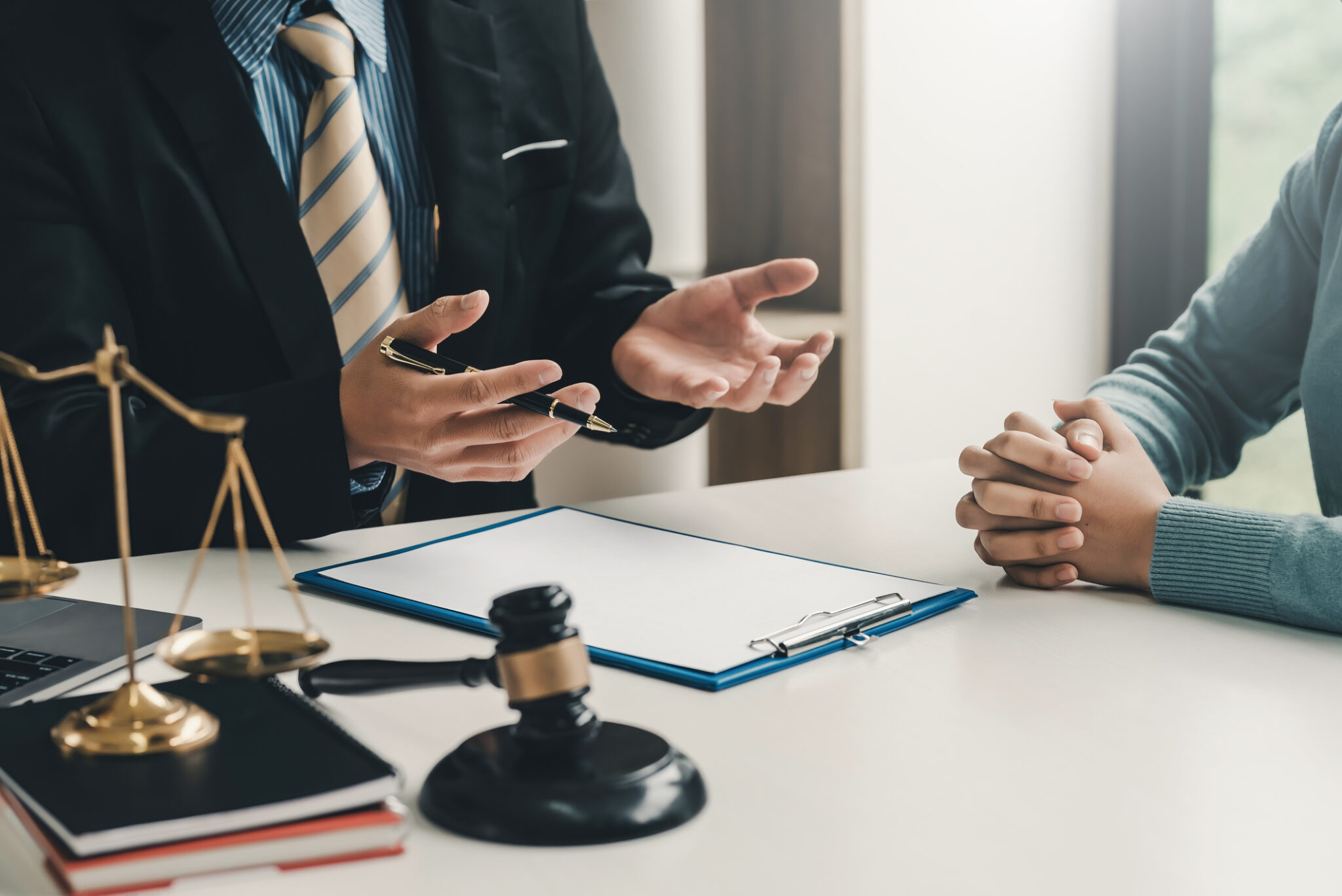 Lawyer consulting client with legal documents.