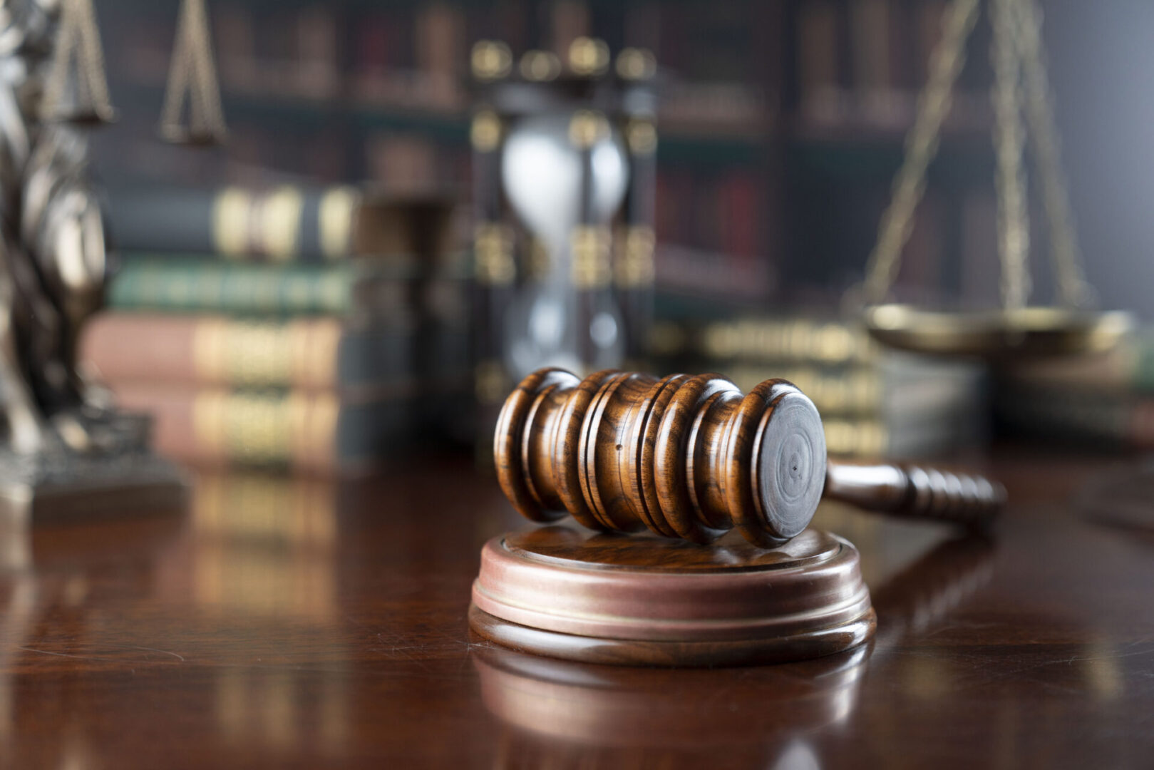 Gavel on desk with legal books background.
