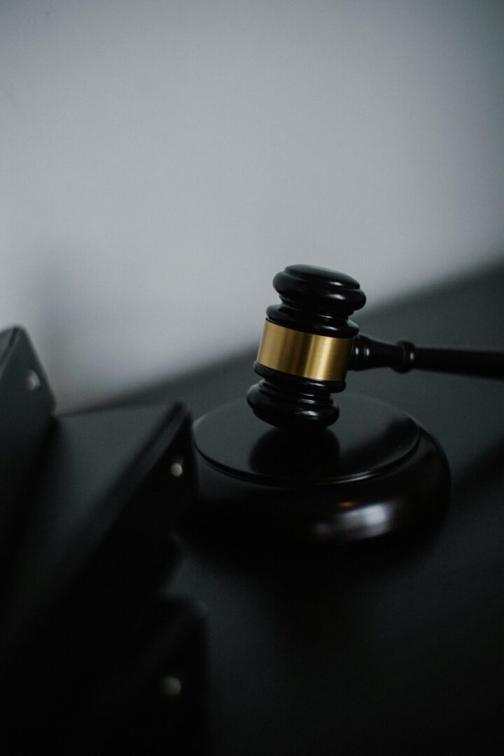 Gavel on a dark wooden surface.